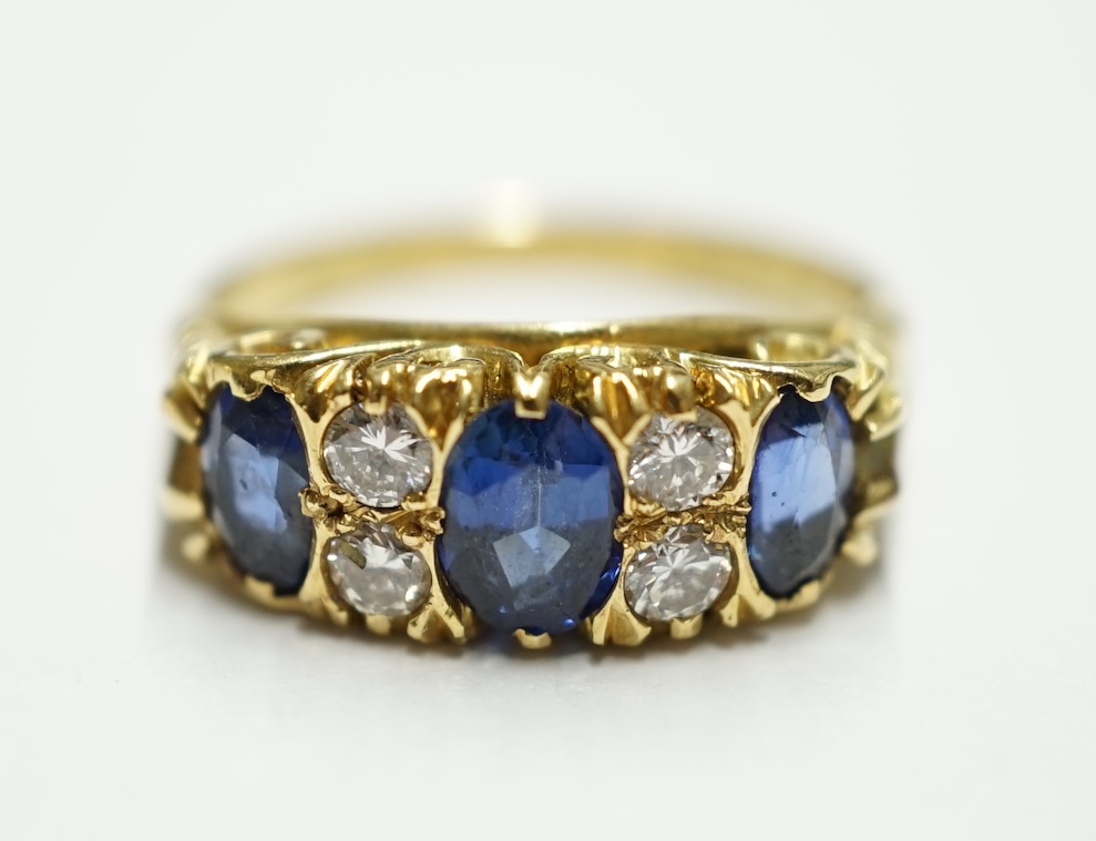 An Edwardian style 18ct gold, three stone sapphire and four stone diamond set half hoop ring, size H, gross weight, 4.9 grams. Condition - fair